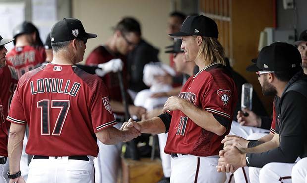 Arizona Diamondbacks starting pitcher Zack Greinke (21) shakes hands with manager Torey Lovullo as ...
