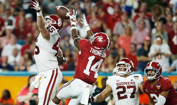 Deionte Thompson #14 of the Alabama Crimson Tide breaks the pass intended for Carson Meier #45 of t...