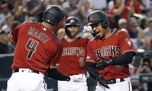 Arizona Diamondbacks' Eduardo Escobar, right, celebrates with teammate Ketel Marte (4) after hittin...