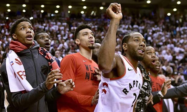 Toronto Raptors forward Kawhi Leonard (2) and teammates watch as the ball bounces around the rim as...