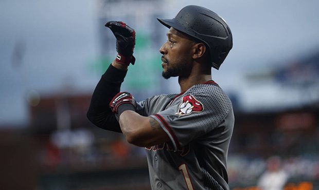 Arizona Diamondbacks' Jarrod Dyson reacts as he walks back to the dugout after hitting a home run o...