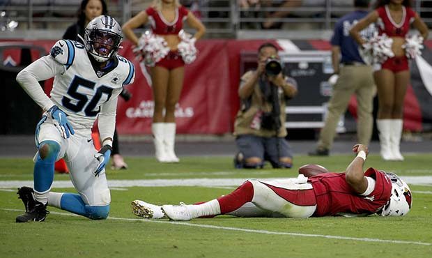 Arizona Cardinals quarterback Kyler Murray lies on the field after being sacked by Carolina Panther...