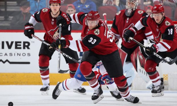 Alex Goligoski #33 of the Arizona Coyotes passes the puck during the NHL game against the Montreal ...