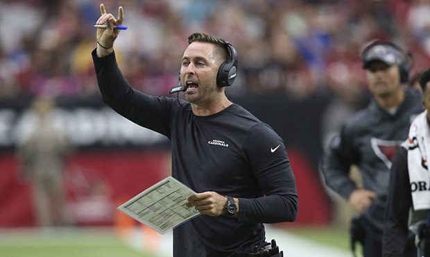 Arizona Cardinals head coach Kliff Kingsbury makes a call during the first half of an NFL football ...