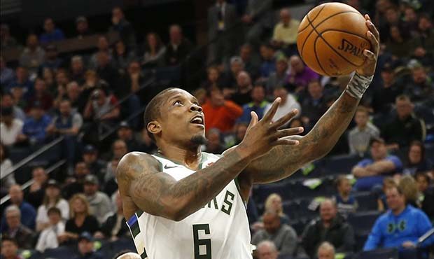 Milwaukee Bucks' Eric Bledsoe, right, lays up a shot as Minnesota Timberwolves' Jeff Teague looks o...
