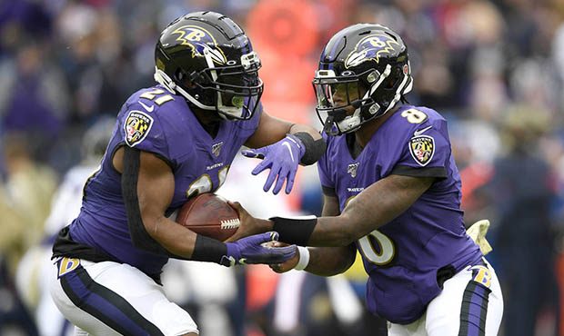 Baltimore Ravens quarterback Lamar Jackson (8) hands off to running back Mark Ingram (21) during th...
