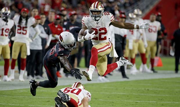San Francisco 49ers running back Matt Breida (22) avoids the tackles of Arizona Cardinals cornerbac...