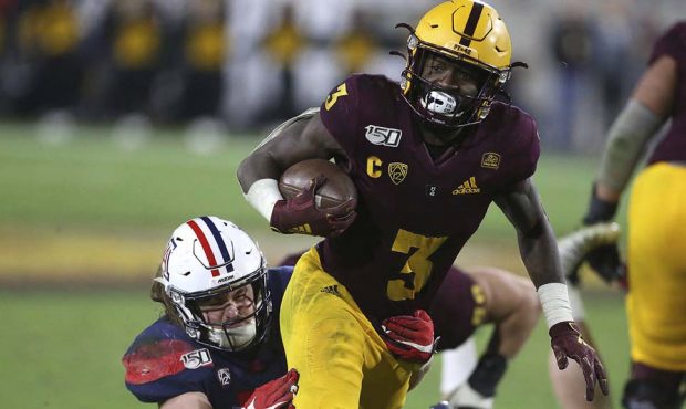 Arizona State's Eno Benjamin (3) slips the tackle of Arizona's Colin Schooler (7) during the second...