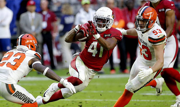 Arizona Cardinals running back Kenyan Drake (41) tries to elude Cleveland Browns free safety Damari...