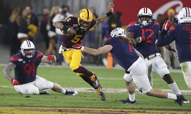 Arizona State's Jayden Daniels (5) runs against Arizona's defense during the first half of an NCAA ...
