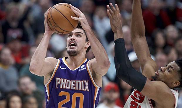 Phoenix Suns forward Dario Saric, left, shoots over Portland Trail Blazers center Hassan Whiteside ...