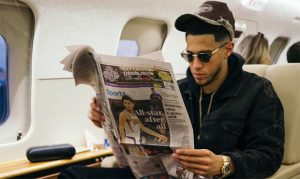 Suns' Devin Booker does some light reading before 1st NBA All-Star Game