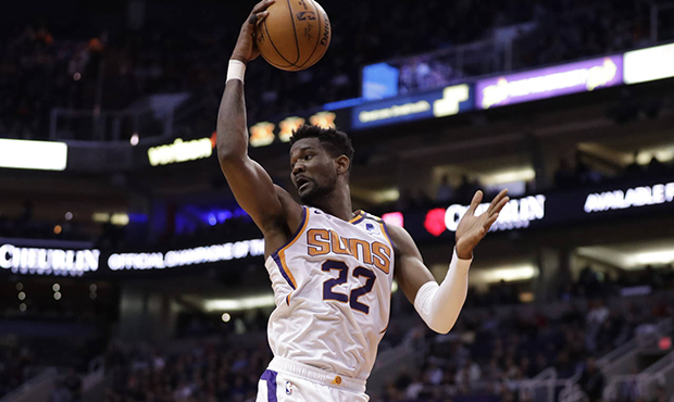 Phoenix Suns center Deandre Ayton (22) rebounds during the first half of an NBA basketball game aga...