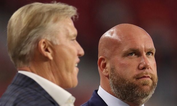 General manager Steve Keim (R) of the Arizona Cardinals talks with general manager and executive vi...