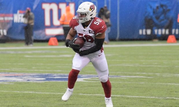 Arizona Cardinals' Jordan Hicks runs the ball after an interception during the first half of an NFL...