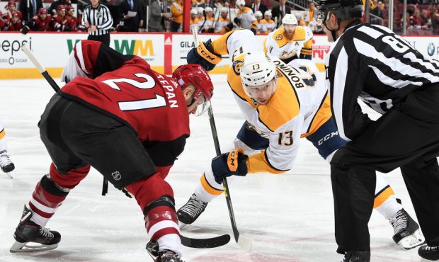 Nick Bonino #13 of the Nashville Predators takes a faceoff against Derek Stepan #21 of the Arizona ...