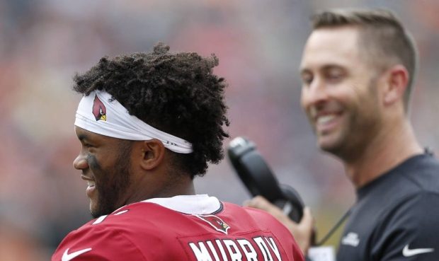 Arizona Cardinals quarterback Kyler Murray, left, speaks with head coach Kliff Kingsbury, right, in...