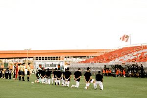 Phoenix Rising FC players take a knee before first game back