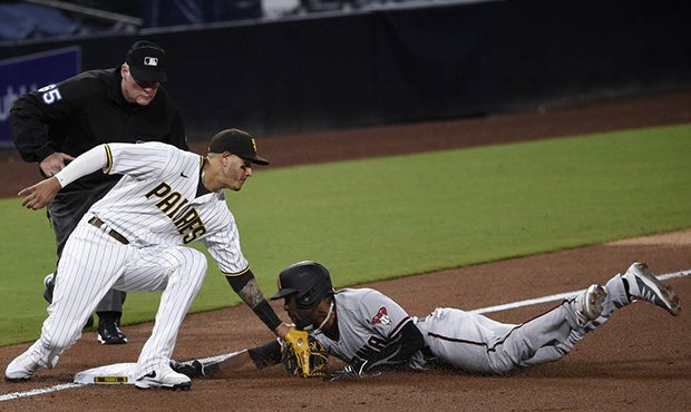 San Diego Padres third baseman Manny Machado, left, tags out Arizona Diamondbacks' Starling Marte a...