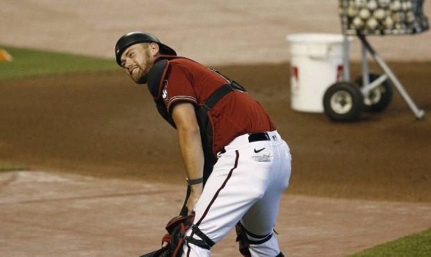 Arizona Diamondbacks catcher Carson Kelly smiles as he picks up his gear bag during team practice a...
