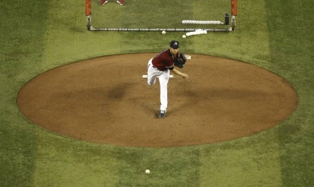Arizona Diamondbacks starting pitcher Merrill Kelly throws during live batting practice during team...