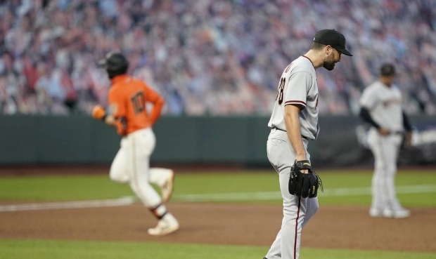 Arizona Diamondbacks pitcher Robbie Ray, front right, stands on the mound as San Francisco Giants' ...