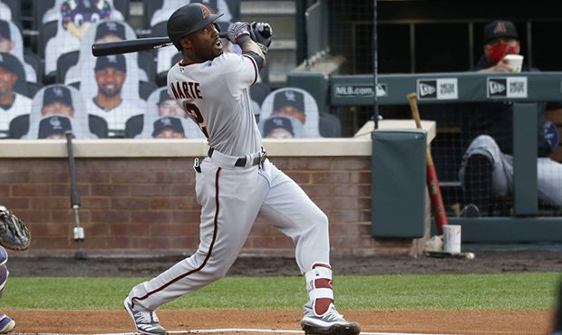 Arizona Diamondbacks' Starling Marte watches his sacrifice fly off Colorado Rockies starting pitche...