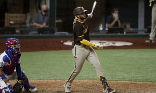 Texas Rangers catcher Jose Trevino and San Diego Padres' Fernando Tatis Jr. watch the flight of Tat...