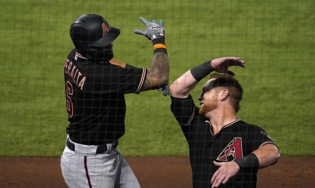 Arizona Diamondbacks' David Peralta, left, celebrates his solo home run with Kole Calhoun during th...
