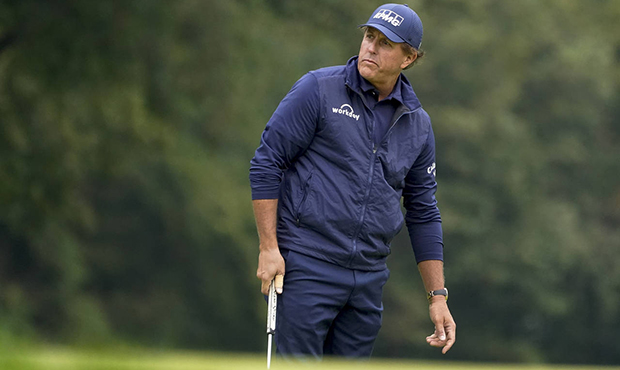Phil Mickelson, of the United States, watches his birdie attempt on the 13th green during the secon...