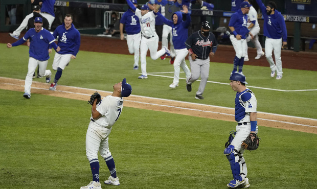 Los Angeles Dodgers starting pitcher Julio Urias celebrates their win against the Atlanta Braves in...