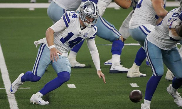 Dallas Cowboys quarterback Andy Dalton (14) chases after fumbling the snap in the second half of an...