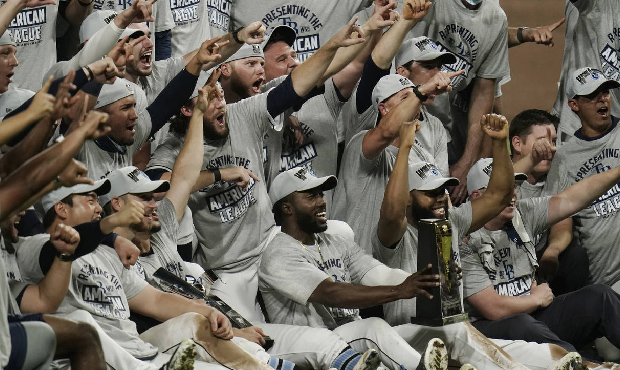 Tampa Bay Rays pose with the American League championship trophy following their victory against th...