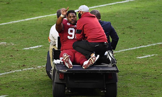 Defensive tackle Corey Peters #98 of the Arizona Cardinals is carted off the field during the first...