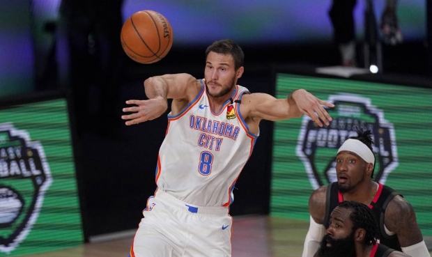 Oklahoma City Thunder's Danilo Gallinari (8) passes the ball as Houston Rockets' James Harden, bott...