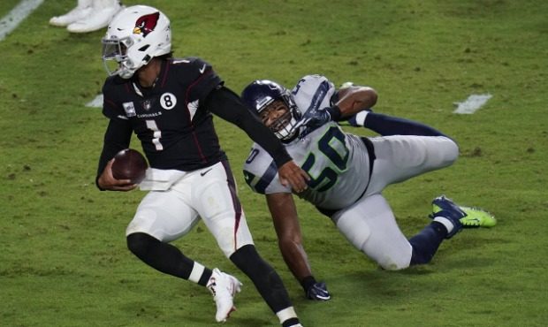 Arizona Cardinals quarterback Kyler Murray (1) breaks the tackle of Seattle Seahawks outside lineba...