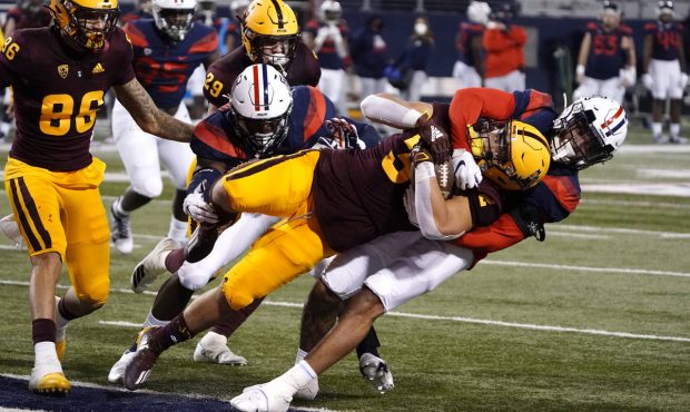 Arizona State running back Jackson He (32) scores a touchdown with Arizona defensive back Jaxen Tur...