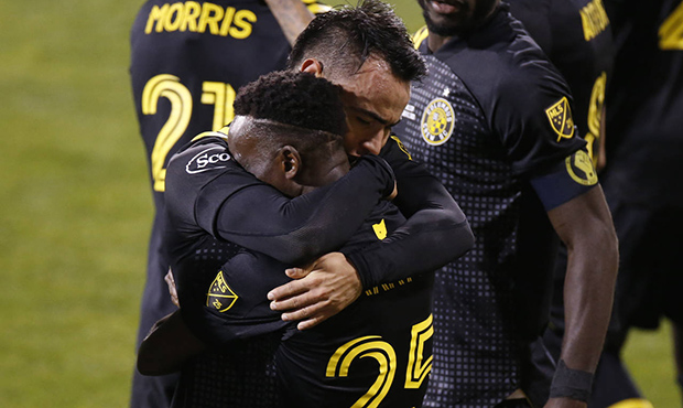 Columbus Crew's Lucas Zelarayan, top, celebrates his goal against the Seattle Sounders with Harriso...