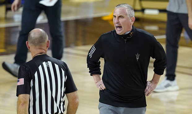 ASU head coach Bobby Hurley takes a tumble arguing with the refs