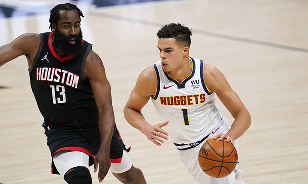 Denver Nuggets forward Michael Porter Jr., right, drives as Houston Rockets guard James Harden defe...