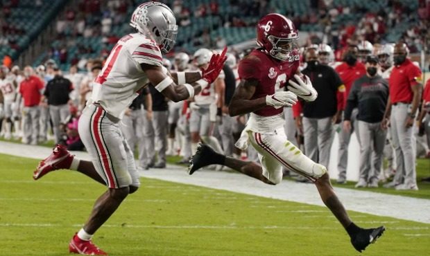 Alabama wide receiver DeVonta Smith scores a touchdown past Ohio State safety Josh Proctor during t...