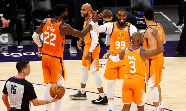 Jae Crowder #99 of the Phoenix Suns high fives Deandre Ayton #22, Chris Paul #3, Devin Booker #1 an...