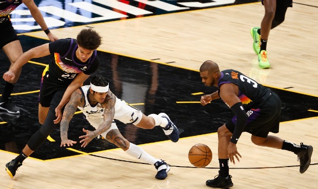Jordan Clarkson #00 of the Utah Jazz turns the ball over to Chris Paul #3 of the Phoenix Suns durin...