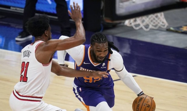 Phoenix Suns forward Jae Crowder, right, drives past Chicago Bulls forward Thaddeus Young, left, du...