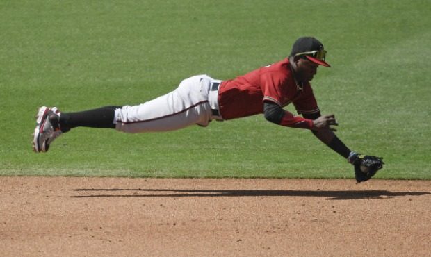 Arizona Diamondbacks Geraldo Perdomo makes a diving stop on a ball hit by San Diego Padres' Wil Mye...