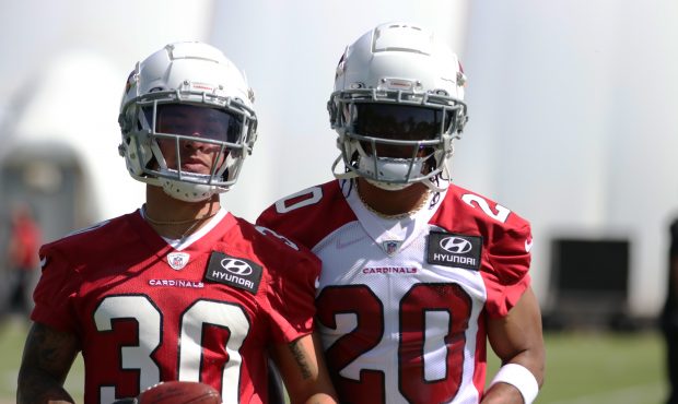 Arizona Cardinals cornerback Marco Wilson (20) and wide receiver Andre Baccellia (30) run through d...