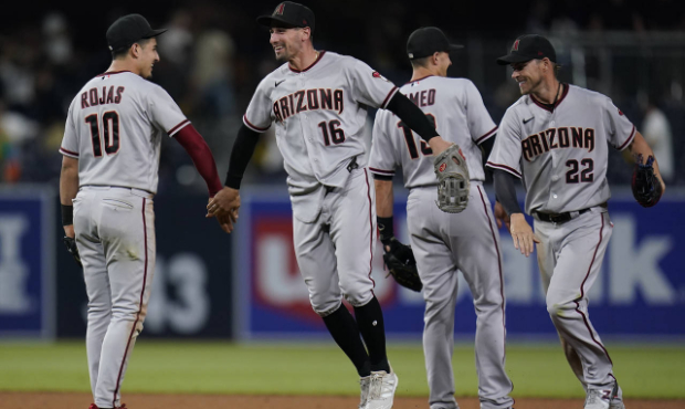 Arizona Diamondbacks left fielder Tim Locastro (16) celebrates with teammates third baseman Josh Ro...