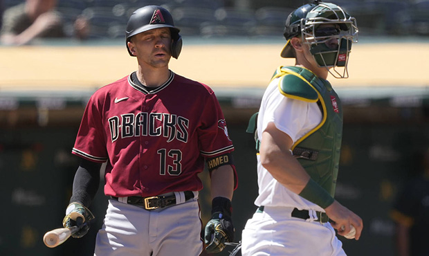 Oakland Athletics catcher Sean Murphy, right, walks toward the mound as Arizona Diamondbacks' Nick ...