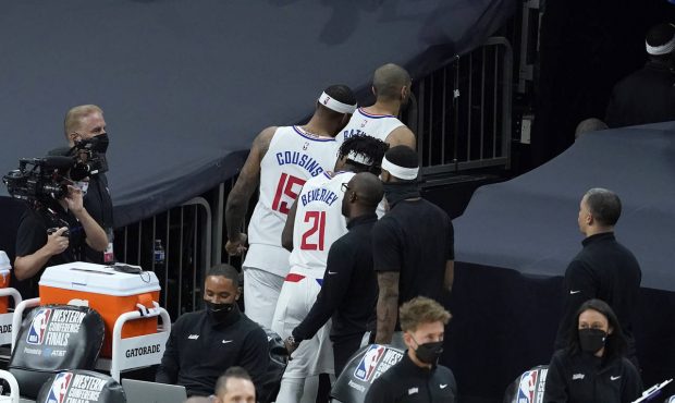 Los Angeles Clippers forward Nicolas Batum, top, walks through a tunnel in front of center DeMarcus...