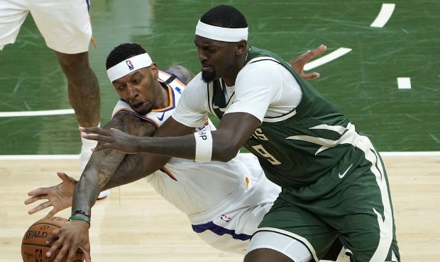 Phoenix Suns forward Torrey Craig (12) and Milwaukee Bucks center Bobby Portis (9) battle for the b...